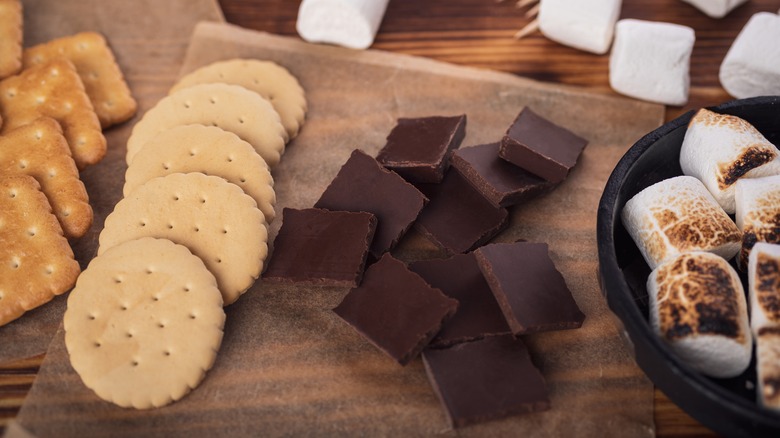 Crackers, chocolate squares, and marshmallows on a tray