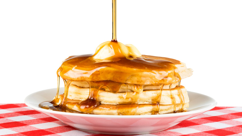 maple syrup poured over pancakes