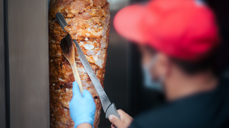 Chef cutting shawarma meat