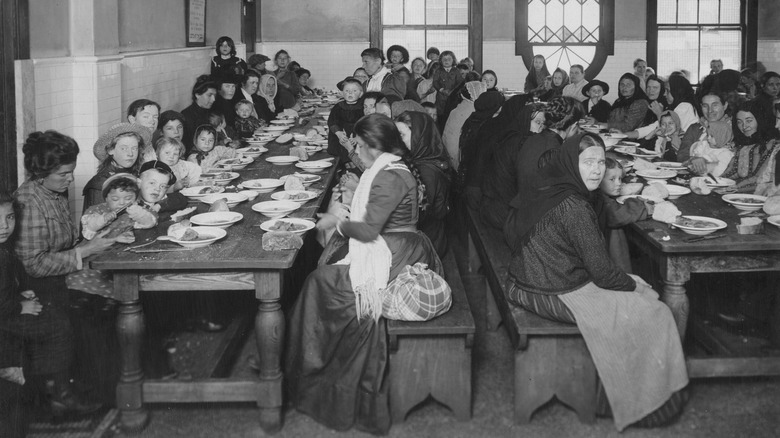 Immigrants in the dining hall in Ellis Island