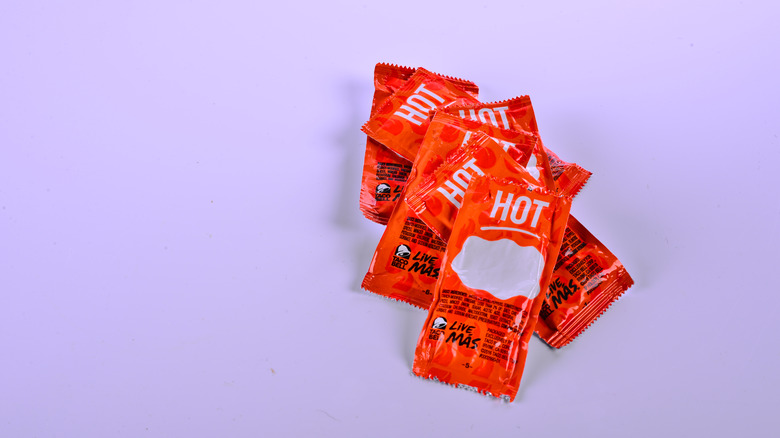 taco bell hot sauce packets with purple background 