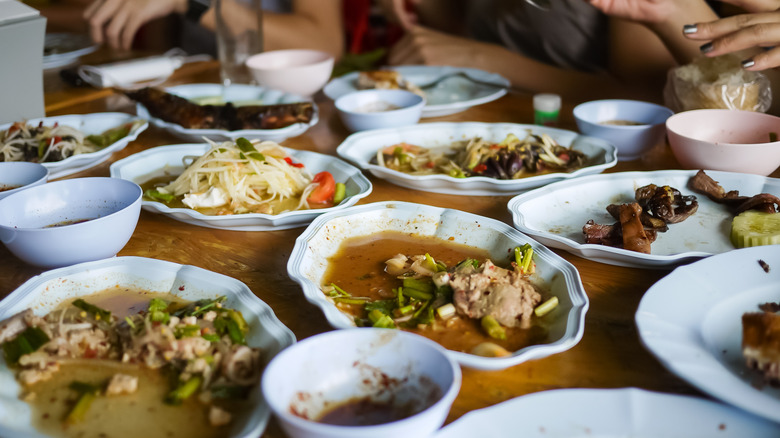 Half-eaten plates of food on a restaurant table