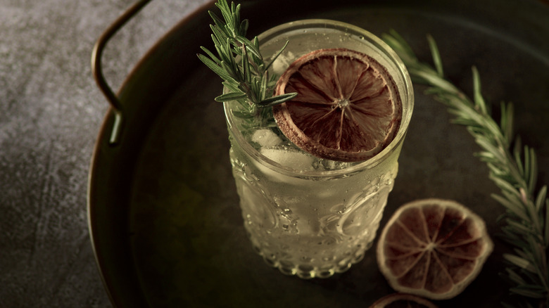 cocktail garnished with dried black lime