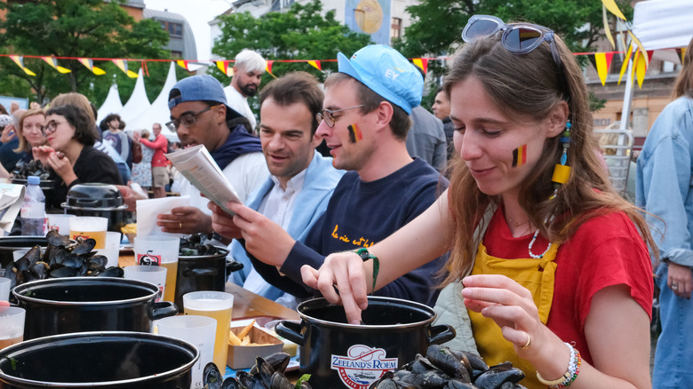 Belgian people eating mussels