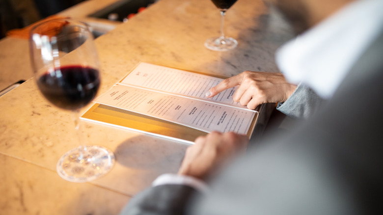Diners read a static menu
