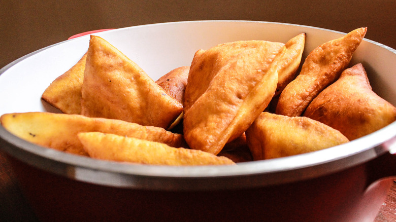 Dish of triangular mandazi doughnuts