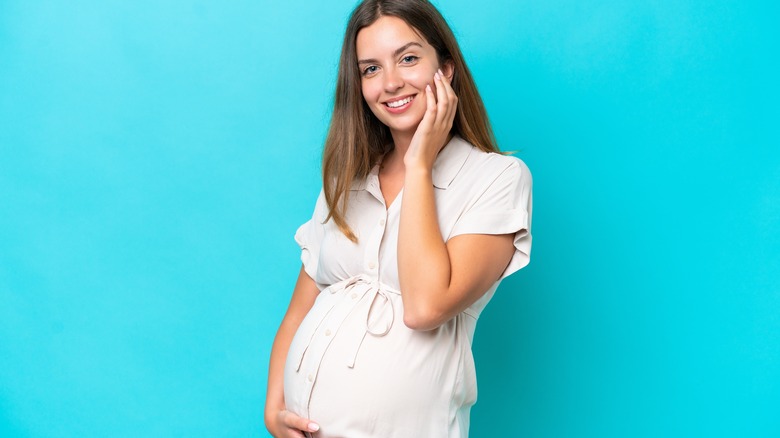 pregnant woman against blue background