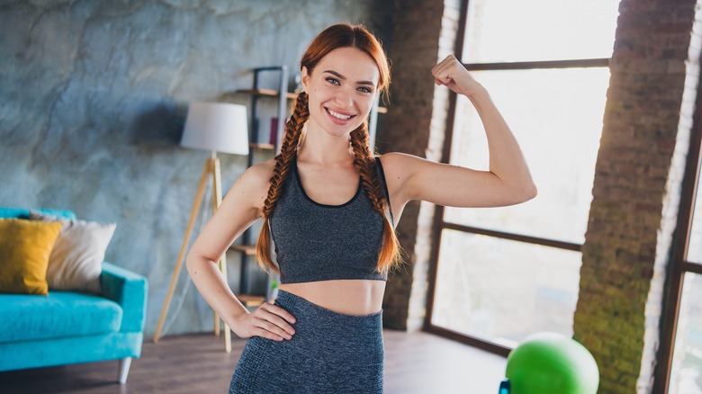 young woman flexing bicep