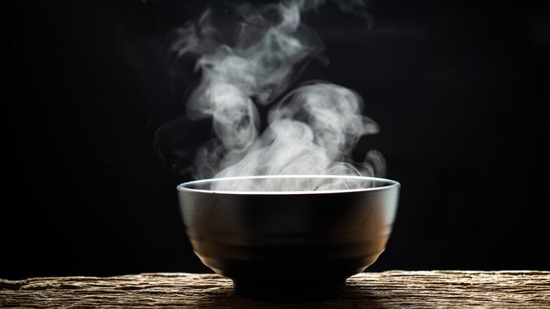 black soup bowl with steam