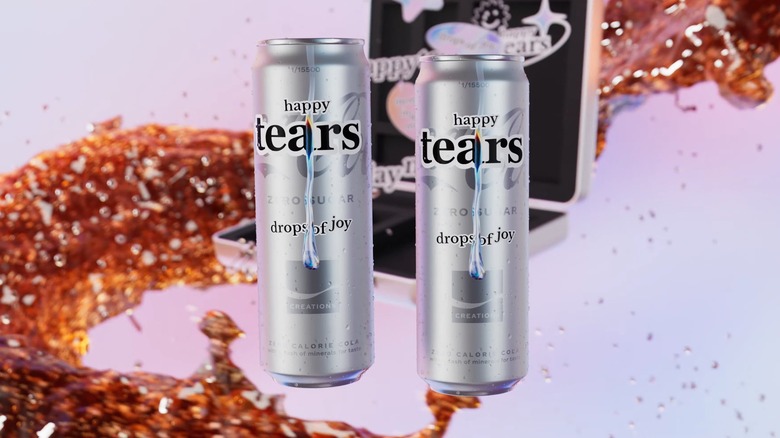 two cans of Coca-Cola Happy Tears Zero Sugar