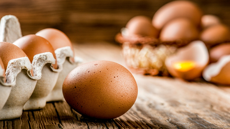 Brown egg outside of carton