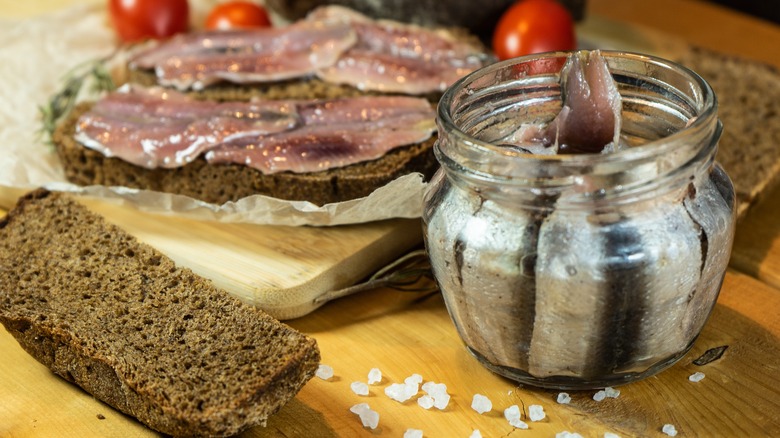 Jar of anchovies with bread