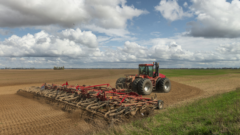 Agricultural machine tilling a field