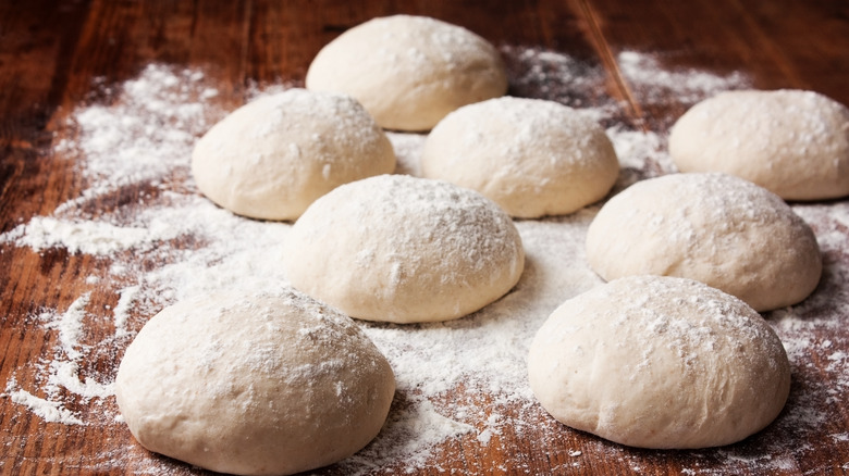 Pizza dough balls on a floured counter top