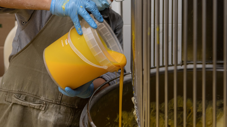 Pouring eggs into industrial mixer