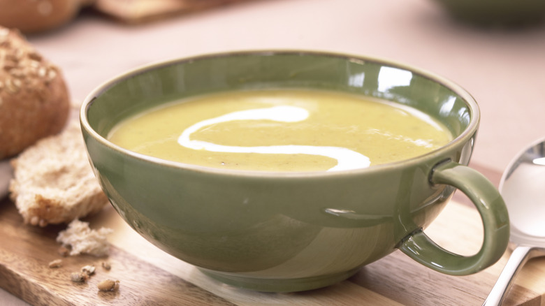 Creamy soup in black bowl