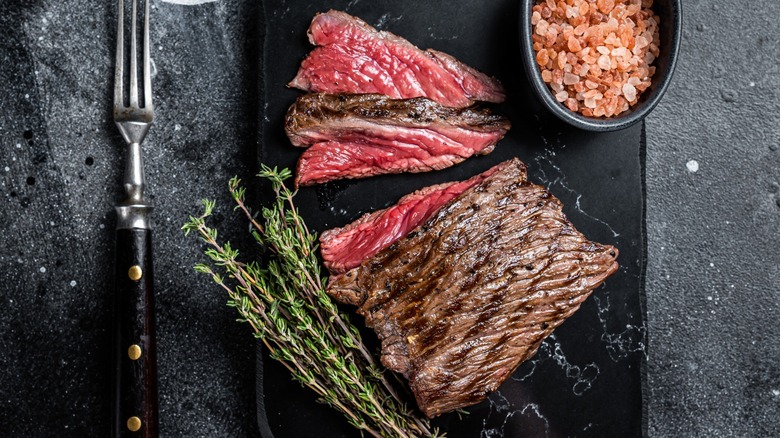 Overview of grilled venison steak and salt