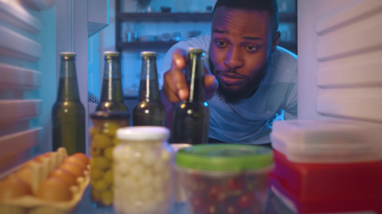 Man getting beer from refridgerator