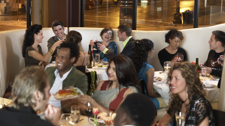 well dressed diners have fun in a fancy restaurant