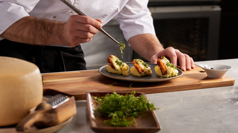 chef puts the finishing touches on a gourmet meal