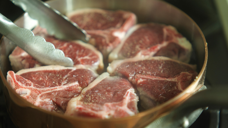 lamb chops sautéing in pan