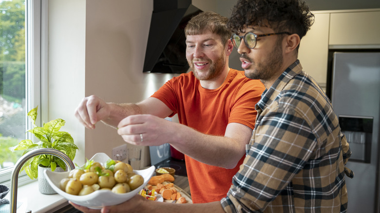 Couple preparing salt potatoes 