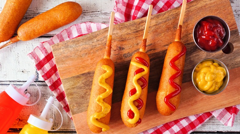 Corn dogs with ketchup and mustard