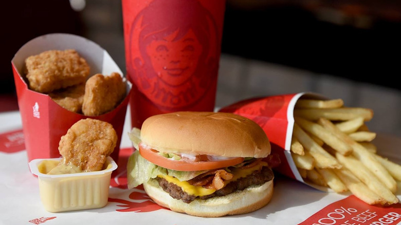 Wendy's burger, fries, nuggets, and soda on paper