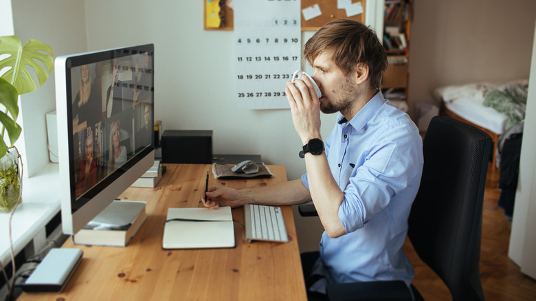 person drinking coffee while working