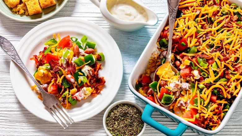 Cornbread salad on plate with fork and casserole dish