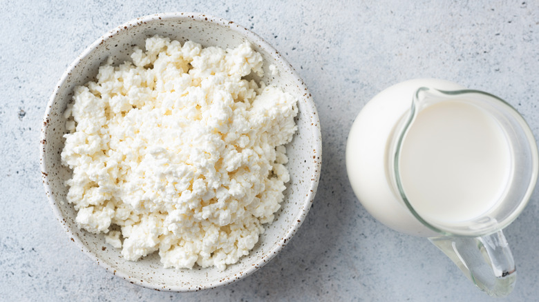 Close up of cottage cheese and pitcher of milk