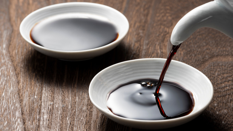 Pouring shoyu into a ramekin