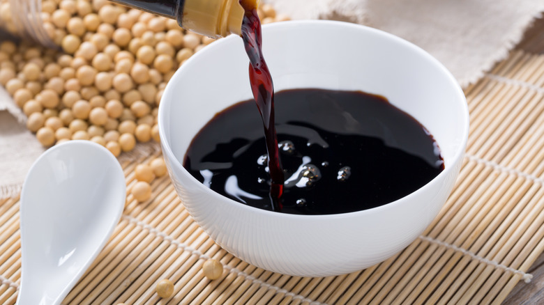 Pouring shoyu into a ramekin