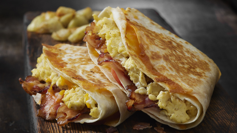 tortilla stuffed with bacon, scrambled eggs, and cheese