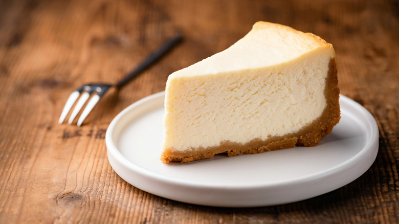 slice of classic cheesecake with graham cracker crust