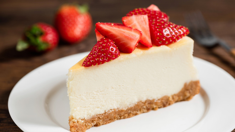 Cheesecake topped with sliced strawberries