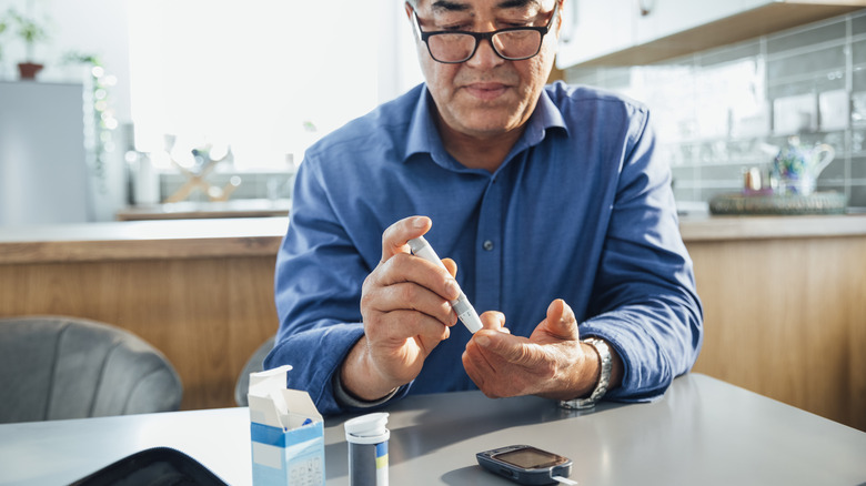 Man checking glucose level