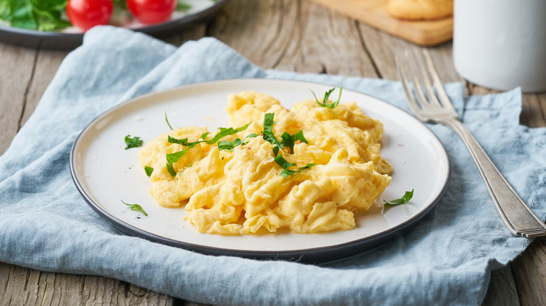 plate of scrambled eggs fork