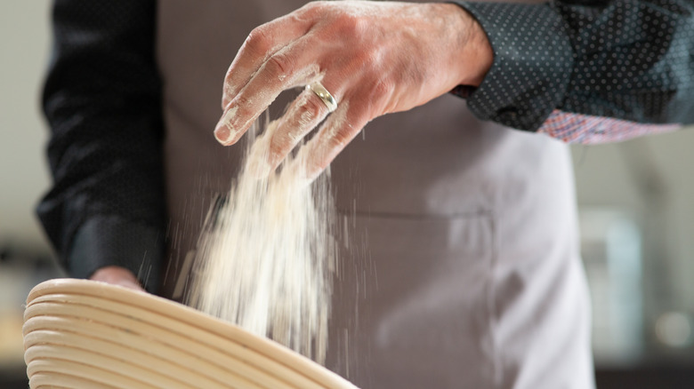 Adding flour to banneton basket 