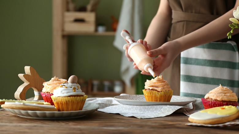 woman decorating cupcakes