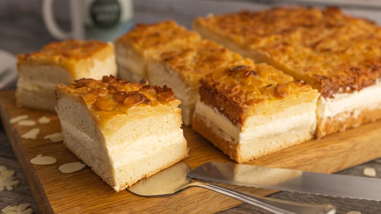 sliced bee sting cake on a wooden board