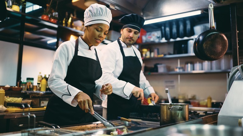 Two chefs preparing food