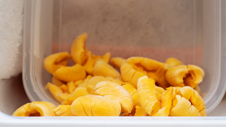 Frozen ackee in plastic container