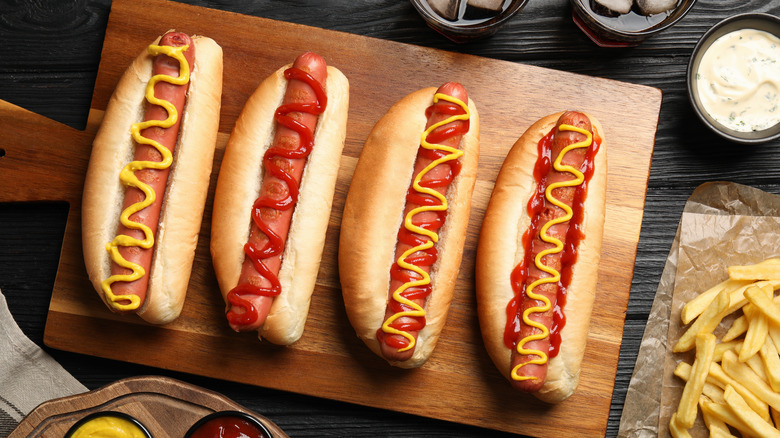 hot dogs in buns on a cutting board