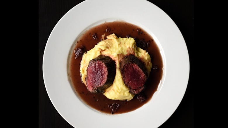 Sliced backstrap with potatoes and gravy