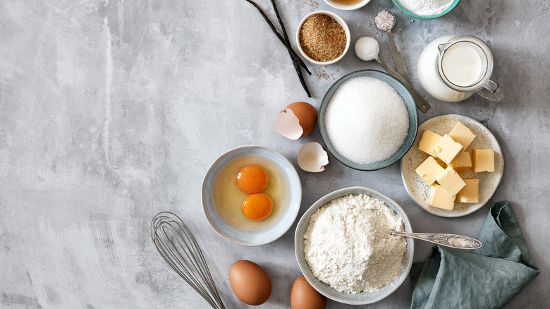 Cake ingredients on grey background