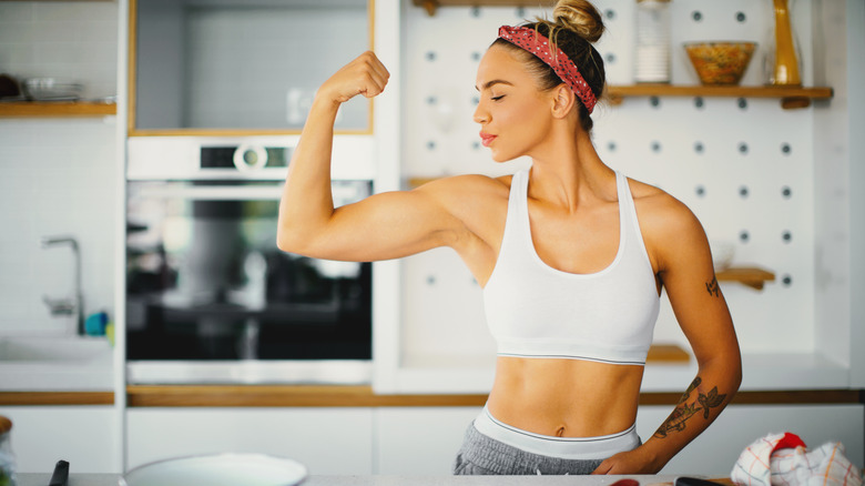 woman in sports bra flexing