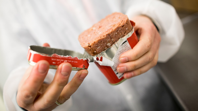 inspecting can of corned beef