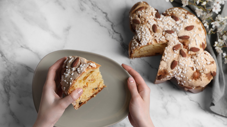 person taking slice of colomba