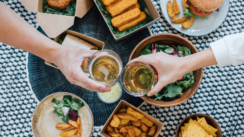 craft beer bottles and food on table 